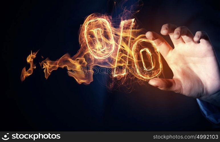 Hot interest rate. Hand touch percent light glowing symbol on dark background