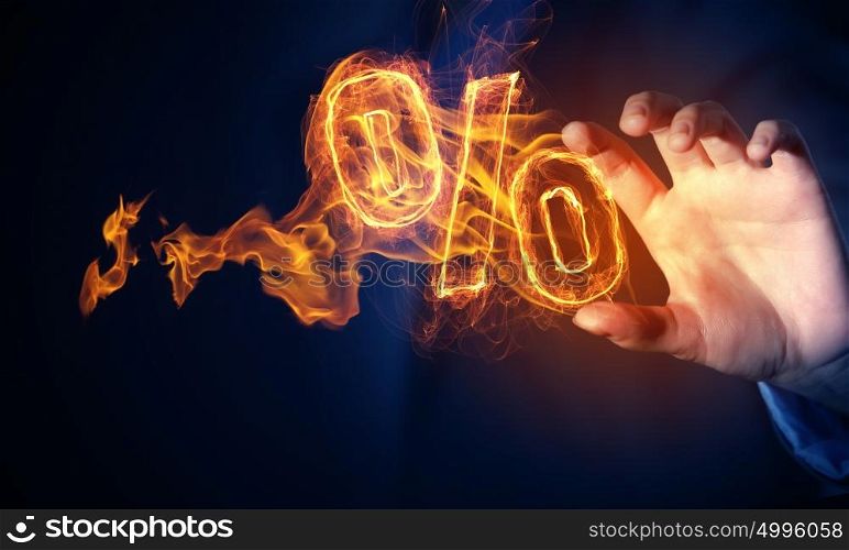 Hot interest rate. Hand touch percent light glowing symbol on dark background
