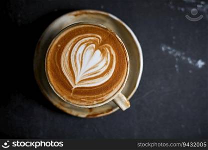 hot latte art coffee on dark background ,selective focus
. hot latte art coffee on dark background