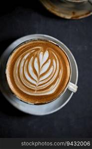 hot latte art coffee on dark background ,selective focus . hot latte art coffee on dark background