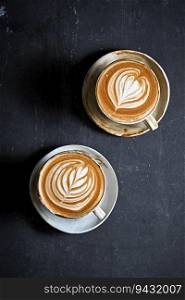 hot latte art coffee on dark background ,selective focus
. hot latte art coffee on dark background
