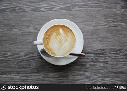 Hot latte coffee on wood background