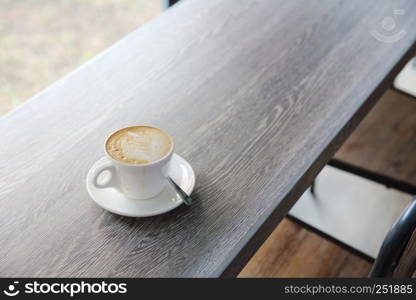 Hot latte coffee on wood background