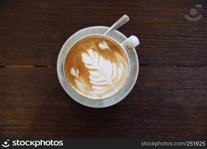 Hot latte coffee on wood background