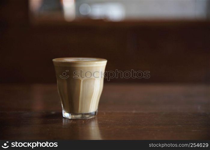 hot latte coffee on wood background