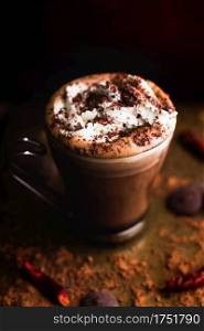 Hot mocha topped with whipped cream and chocolate shavings