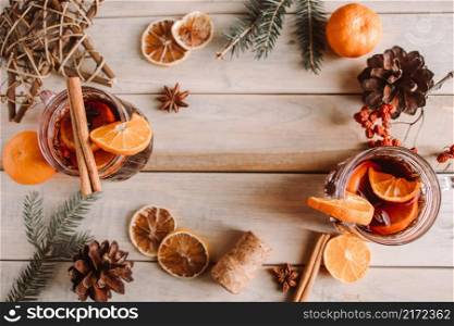 Hot mulled wine with fruits and spices on a wooden background. Winter warming drink for the holidays.. Hot mulled wine with fruits and spices on wooden background. Winter warming drink for the holidays.