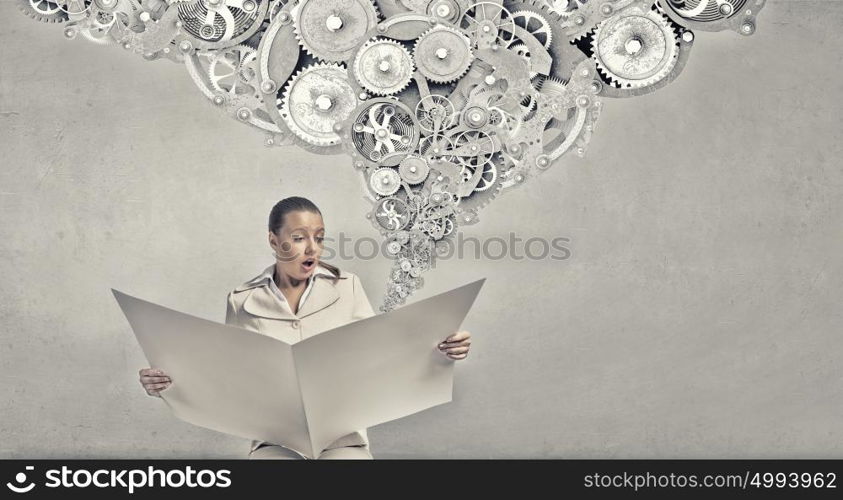 Hot news. Portrait of young businesswoman in white suit reading blank newspaper