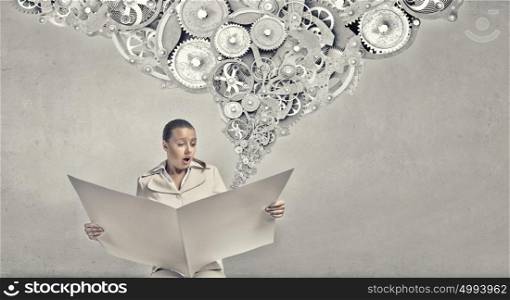 Hot news. Portrait of young businesswoman in white suit reading blank newspaper