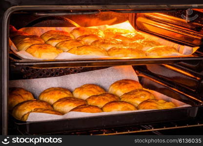Hot oven with golden buns at a bakery