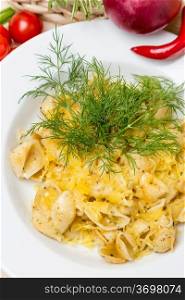 hot pasta with garnish on white plate