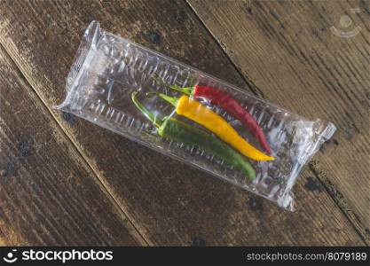 Hot peppers on wooden kitchen cutting board