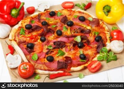 Hot pizza with ingredients on wooden table still life