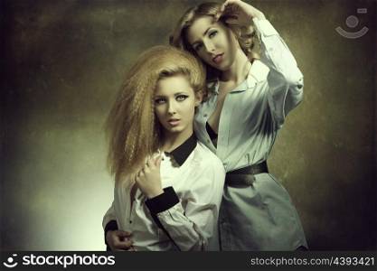 hot portrait of couple blonde girls with creative style, cute make-u, hairdo and open shirt in fashion pose