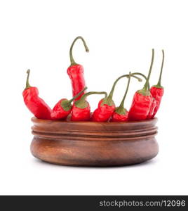 Hot red chili or chilli pepper in wooden bowl isolated on white background cutout