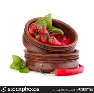 Hot red chili or chilli pepper in wooden bowls stack isolated on white background cutout