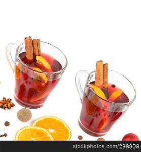 Hot red mulled wine isolated on white background with christmas spices, orange slice, anise and cinnamon sticks, close up. Flat lay, top view. Free space for text.