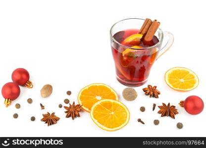 Hot red mulled wine isolated on white background with christmas spices, orange slice, anise and cinnamon sticks, close up. Flat lay, top view. Free space for text.
