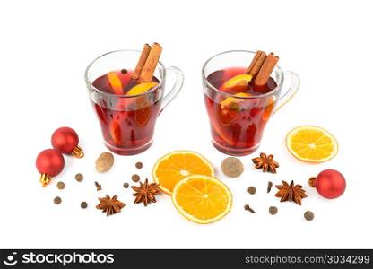 Hot red mulled wine isolated on white background with spices, or. Hot red mulled wine isolated on white background with spices, orange slice, anise and cinnamon sticks, close up. Flat lay, top view.