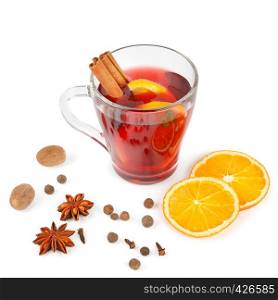 Hot red mulled wine isolated on white background with spices, orange slice, anise and cinnamon sticks, close up. Flat lay, top view.