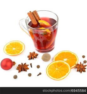 Hot red mulled wine isolated on white background with spices, orange slice, anise and cinnamon sticks, close up. Flat lay, top view.