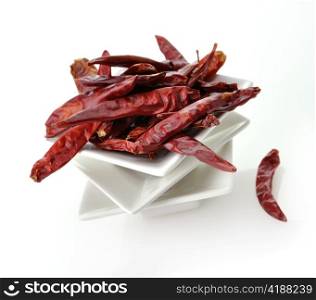 hot red pepper in white dish , closeup