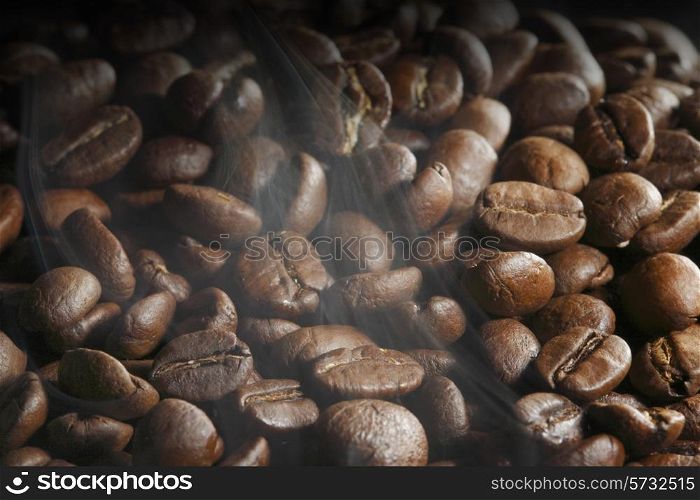 Hot roasted coffee beans and steam