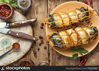 Hot smoked mackerel roll.Delicious smoked fish on wooden table. Appetizing smoked mackerel.