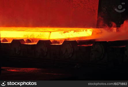 hot steel on conveyor inside of steel plant