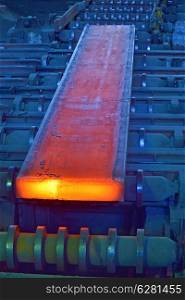 hot steel on conveyor inside of steel plant