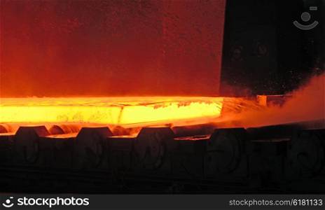 Hot steel on conveyor.production at steel mill