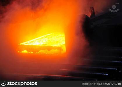 hot steel plate on conveyor in steel mill