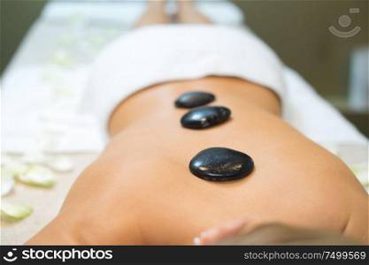 hot stones placed along womans back