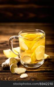 hot sweet ginger tea with lemon in glass mug