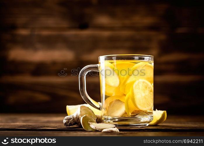 hot sweet ginger tea with lemon in glass mug