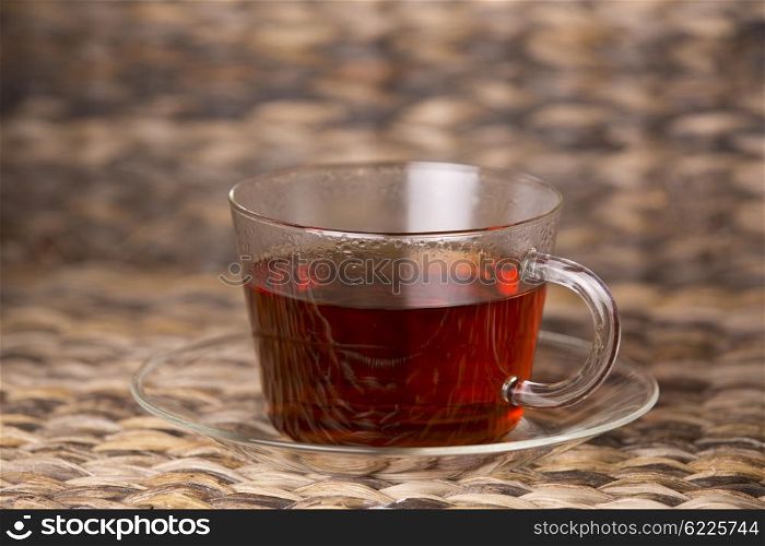 hot tea in glass cup on a wooden table
