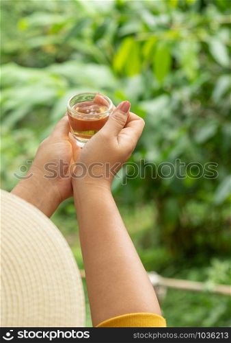 hot tea in her hand In the morning amidst refreshing nature