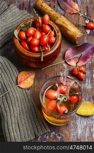 hot tea with berries rose hips. medical tea with ripe berries of the autumn rose