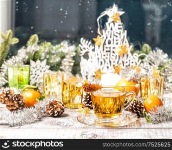 Hot tea with Christmas window decoration. Winter food and drinks