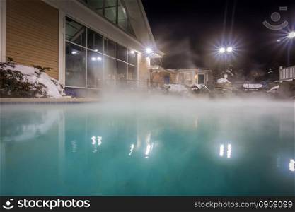 hot tubs and ingound heated pool at a mountain village in winter. hot tubs and ingound heated pool at a mountain village in winter at night. hot tubs and ingound heated pool at a mountain village in winter at night