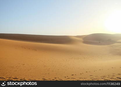 Hot weather in Erg Chebbi sand dunes against clear blue sky background in Sahara desert. Merzouga, Morocco.