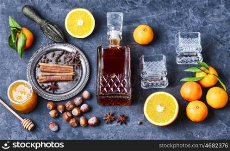 Hot wine with orange and spices set on a dark slate background. winter wine cocktail mulled wine