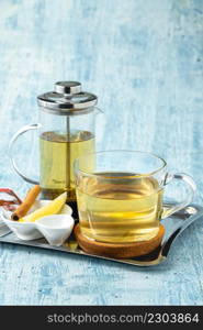 Hot winter tea served with a french press on a wooden table