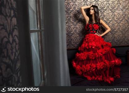 Hot woman in red dress in interior