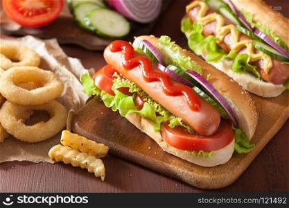 hotdog with ketchup mustard vegetables and french fries