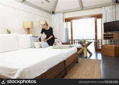 Hotel Chambermaid Making Guest Bed