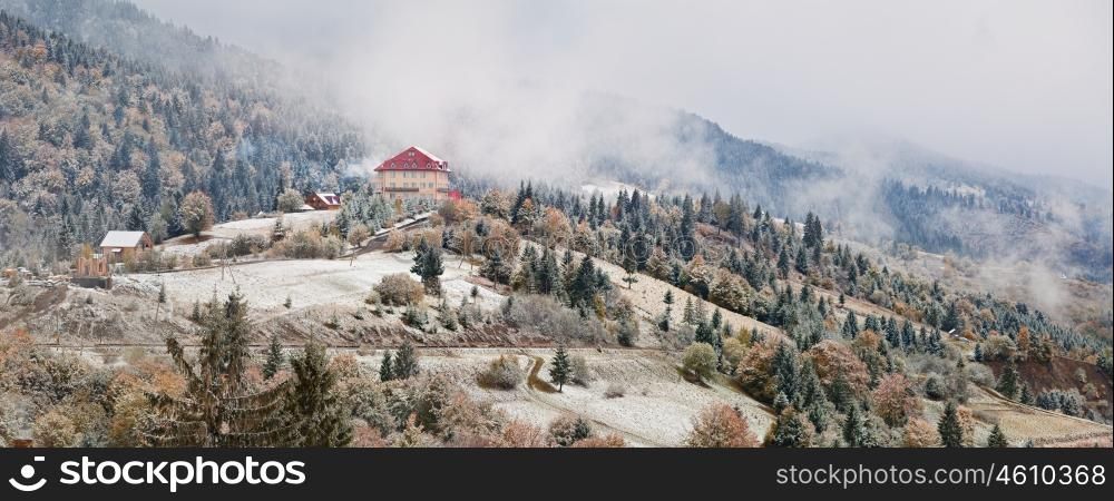 Hotel in mountains. Snow and fog. First snow in autumn. Snowfall in mountains