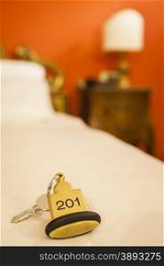 Hotel Room Key lying on Bed with keyring. Hotel Room Key lying on Bed with keyring golden