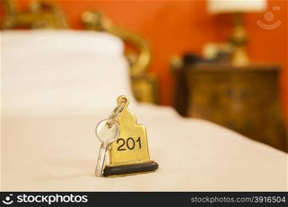 Hotel Room Key lying on Bed with keyring. Hotel Room Key lying on Bed with keyring golden