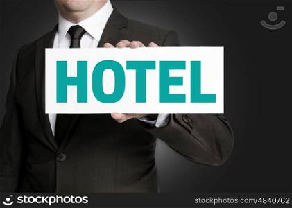 hotel sign is held by businessman concept. hotel sign is held by businessman concept.